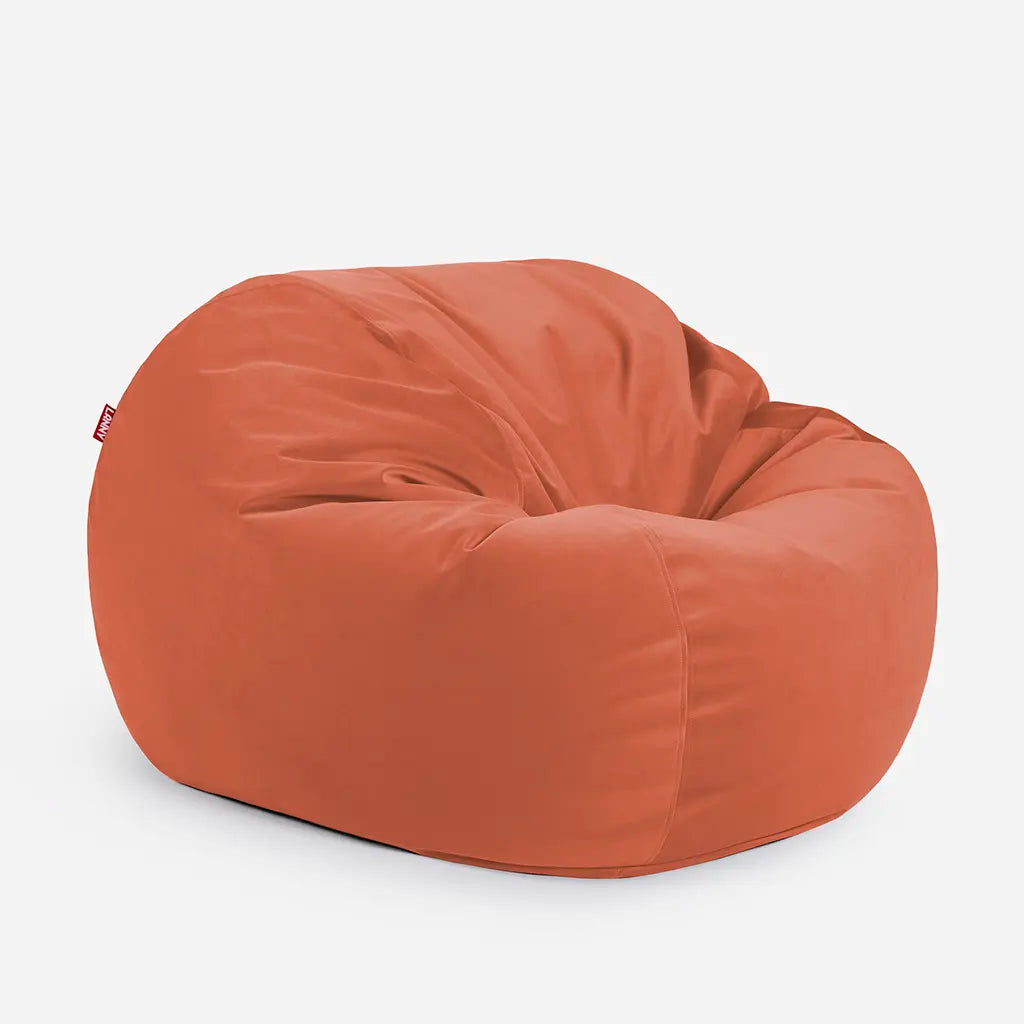 Side angle view of the Lanny Sphere amber velvet bean bag, demonstrating its deep 140cm footprint and structured support for UAE seating