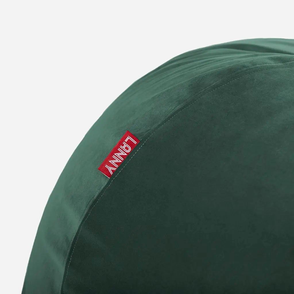 Close-up detail of the Lanny red brand tag and the ultra-soft texture of the green velvet bean bag fabric