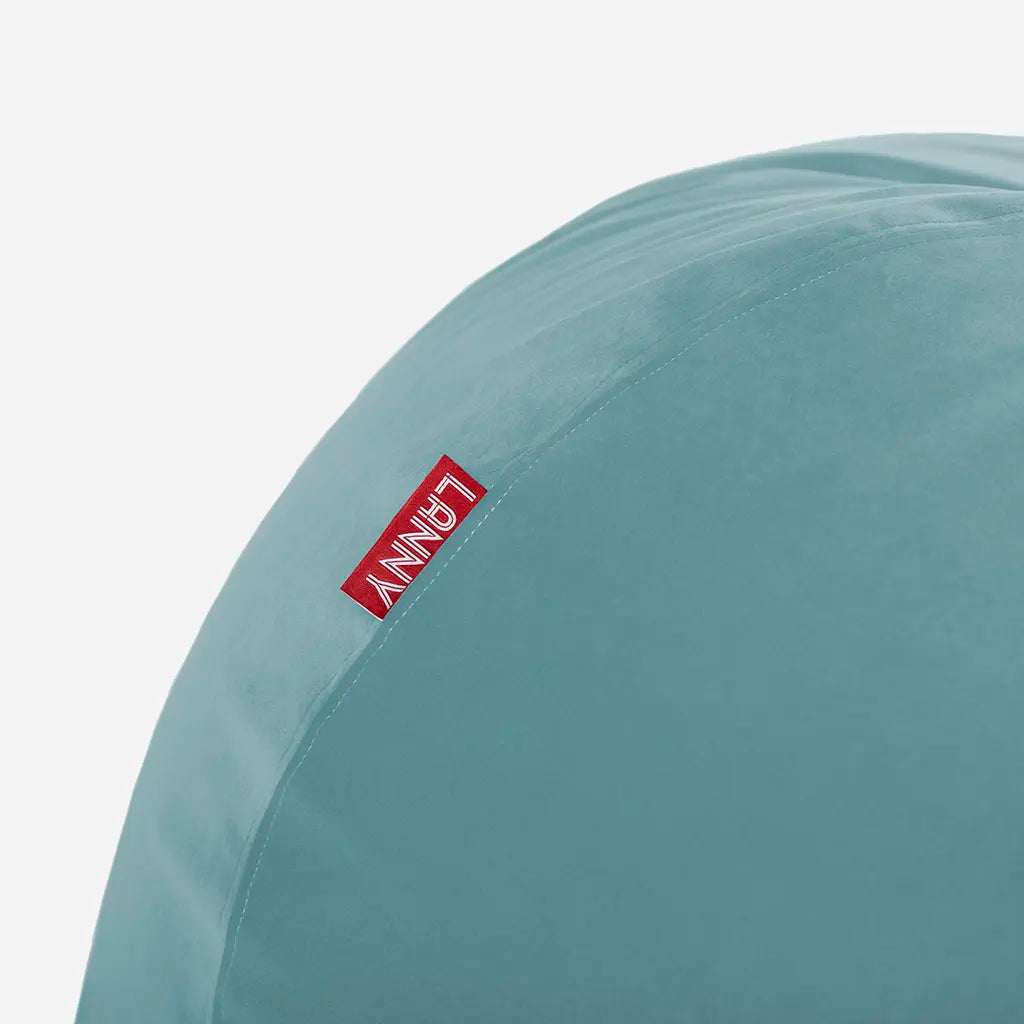 Close-up detail of the Lanny red brand tag and the ultra-soft texture of the Turquoise velvet bean bag fabric