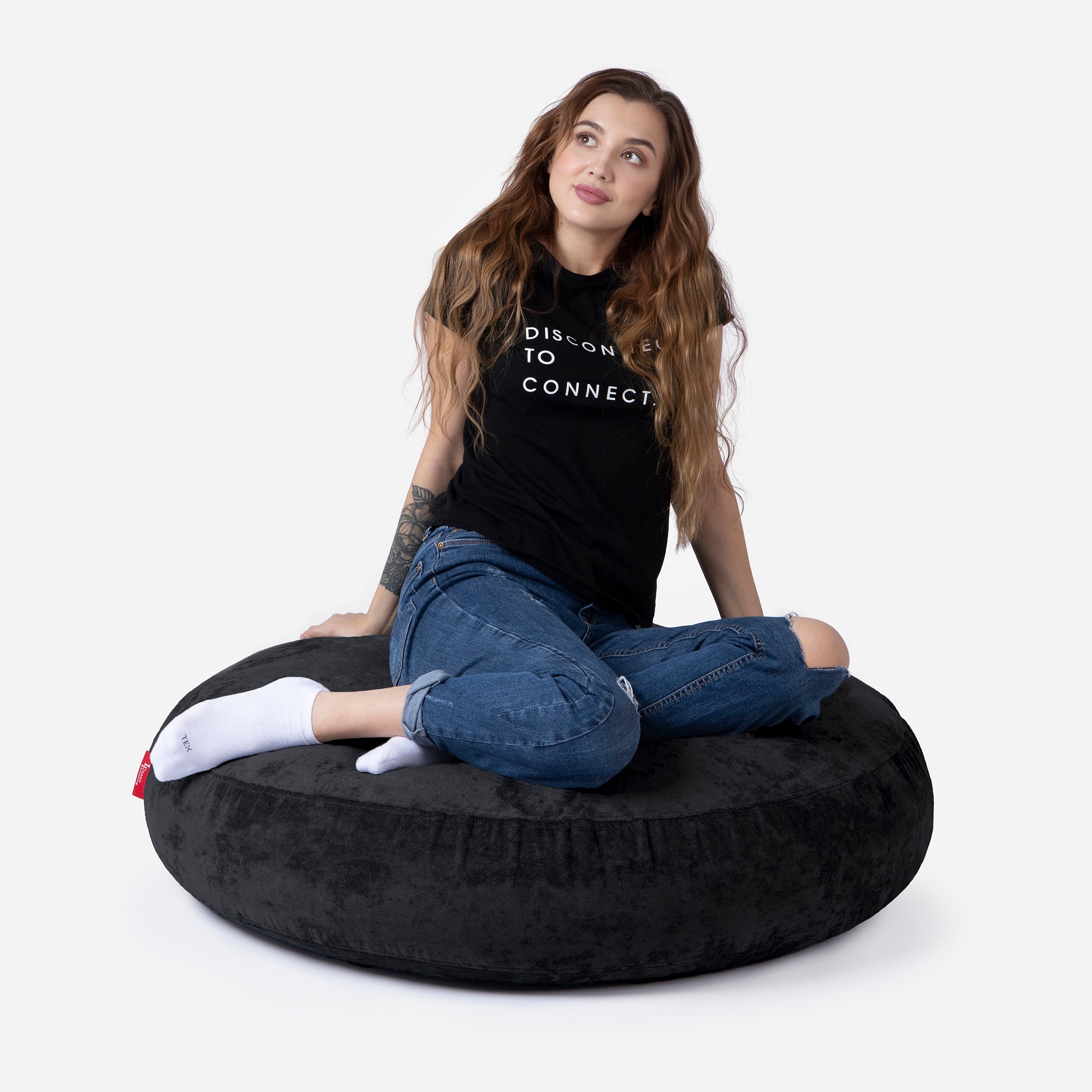 Pouf, Ottoman Black color by Lanny with girl seating on it 