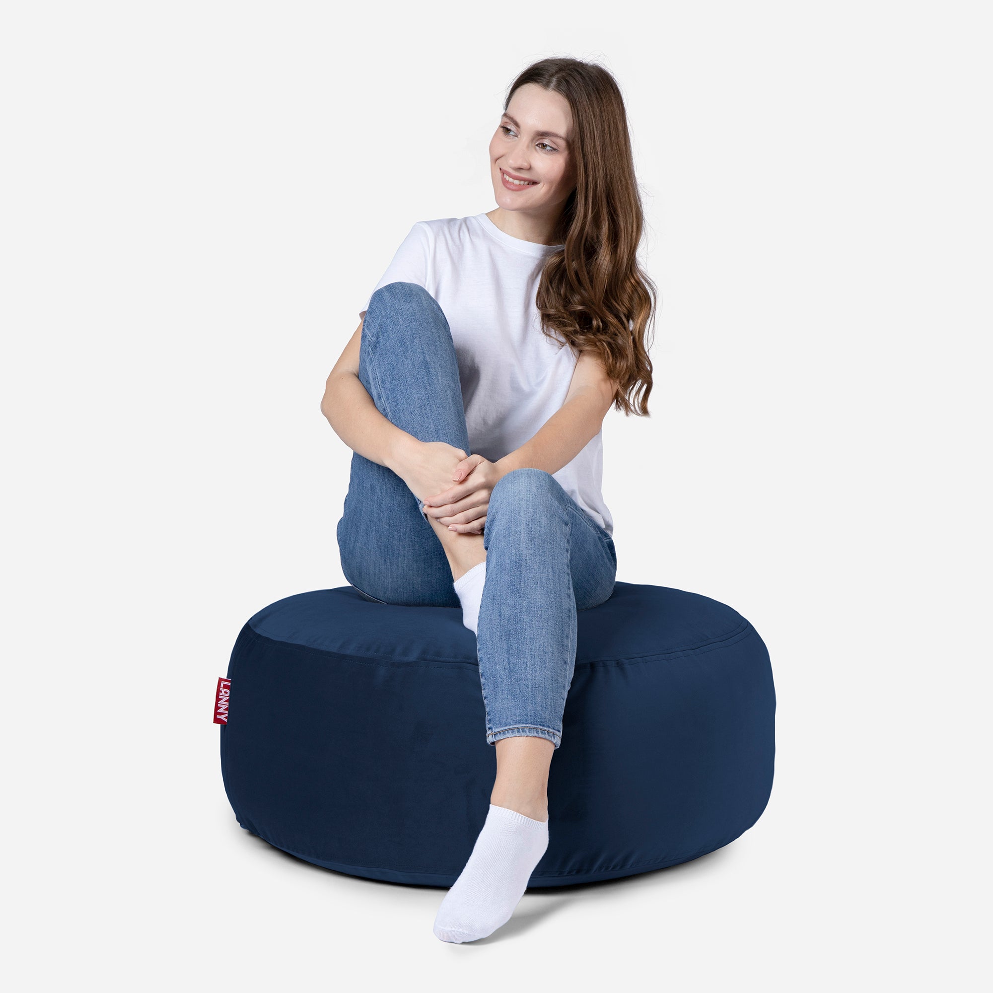 girl siting on Lanny pouf made from velvet fabric in Blue color
