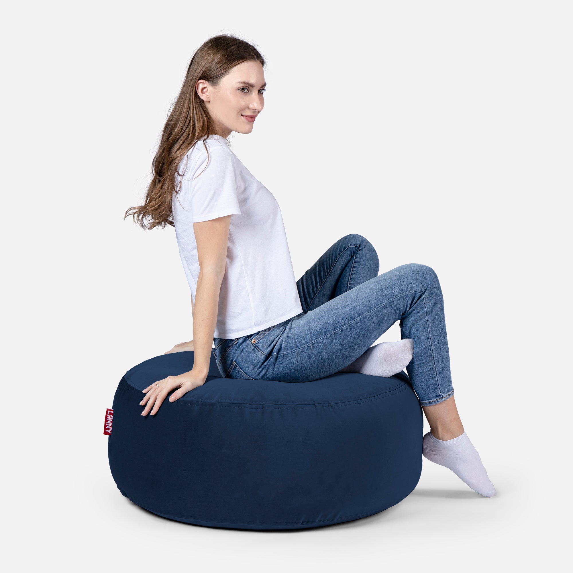 girl siting on Lanny pouf made from velvet fabric in Blue color