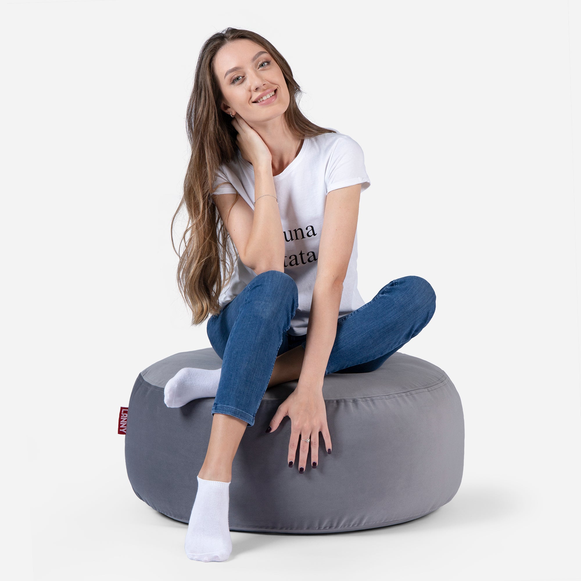 girl siting on Lanny pouf made from velvet fabric in Gray color