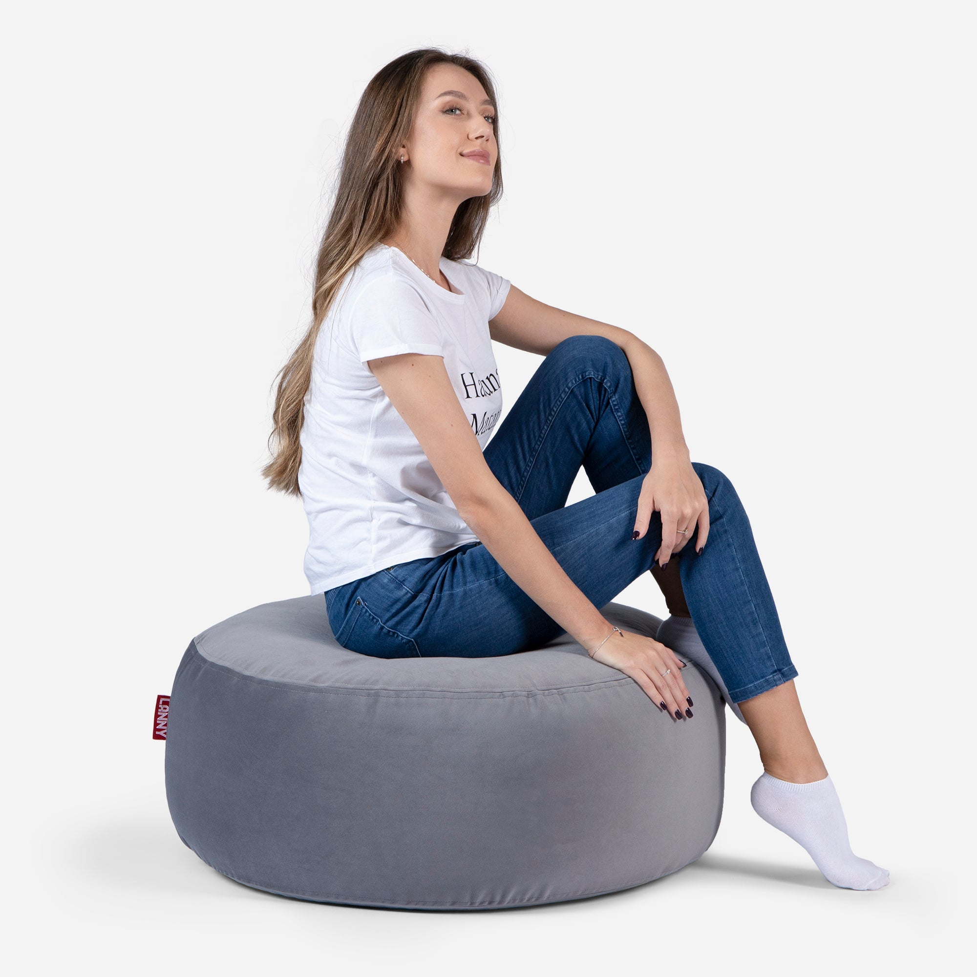 girl siting on Lanny pouf made from velvet fabric in Gray color