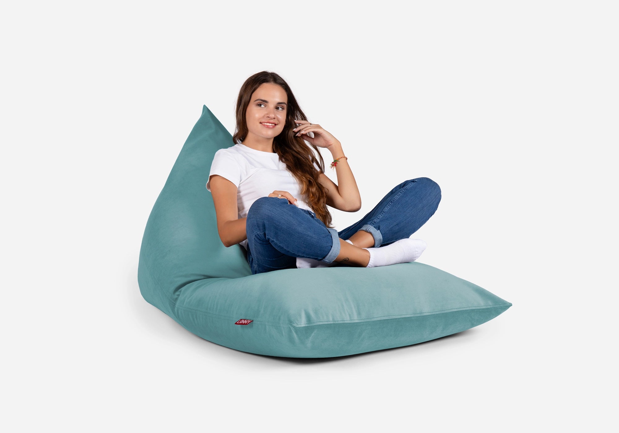 Woman sitting on a Lanny teal bean bag chair against a white background