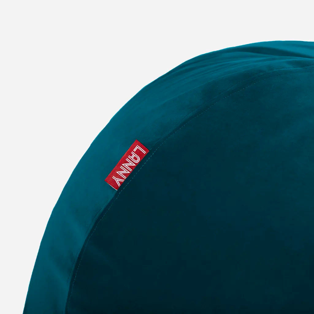 Close-up detail of the Lanny red brand tag and the ultra-soft texture of the Aqua Blue velvet bean bag fabric