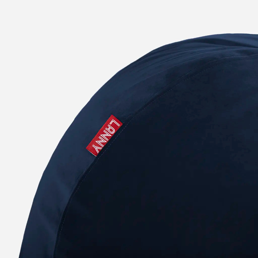 Close-up detail of the Lanny red brand tag and the ultra-soft texture of the Blue velvet bean bag fabric