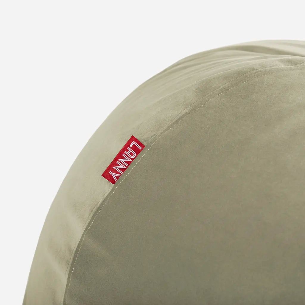 Close-up detail of the Lanny red brand tag and the ultra-soft texture of the khaki green velvet bean bag fabric