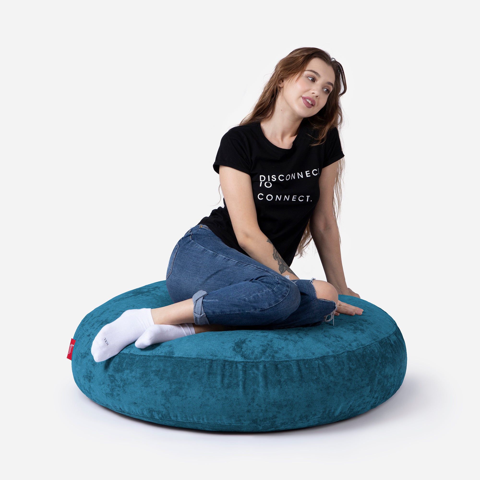 Pouf, Ottoman aqua color by Lanny with girl seating on it 