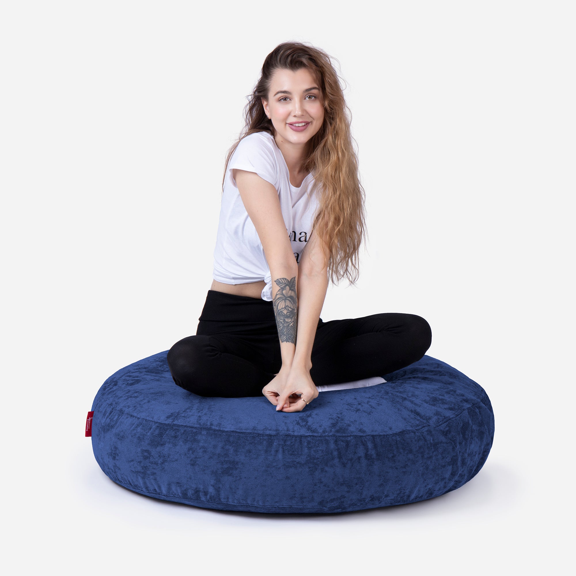 Pouf, Ottoman Blue color by Lanny with girl seating on it 