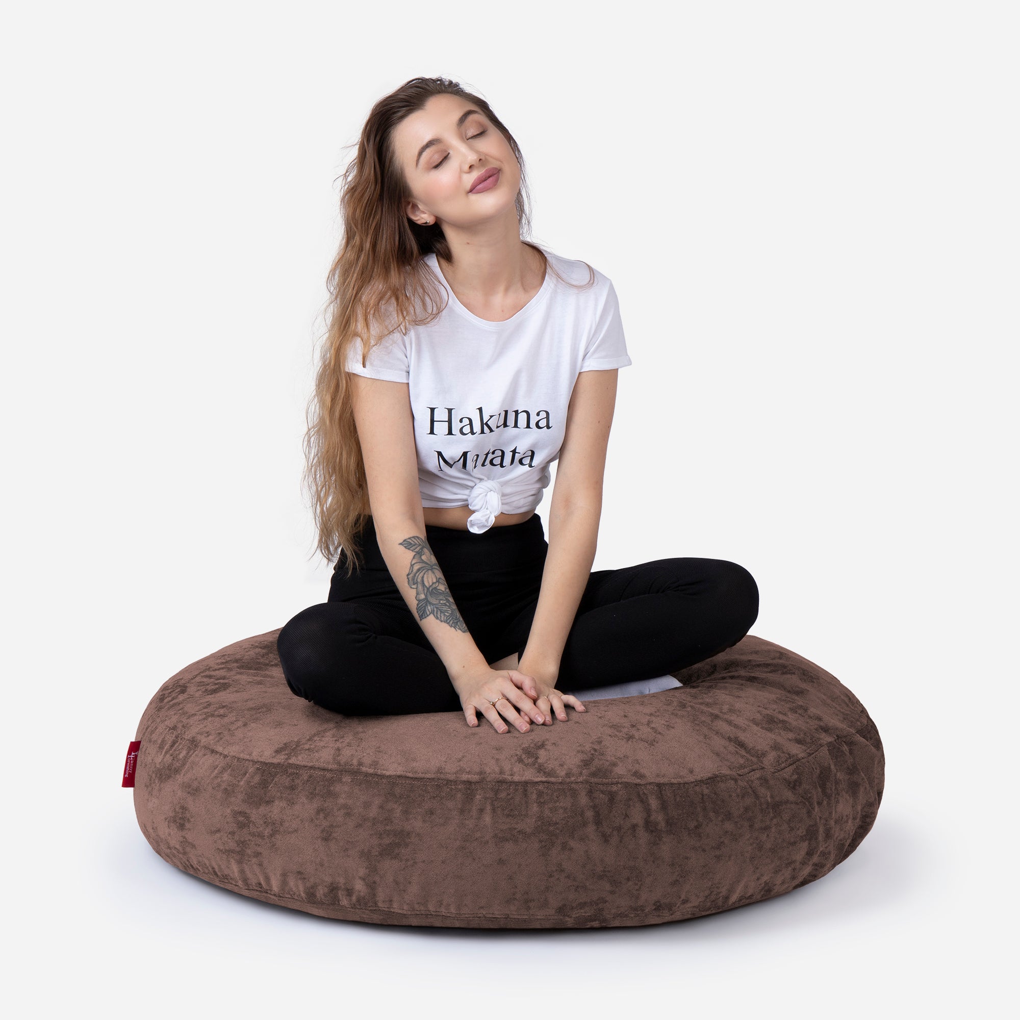 Pouf, Ottoman Brown color by Lanny with girl seating on it 