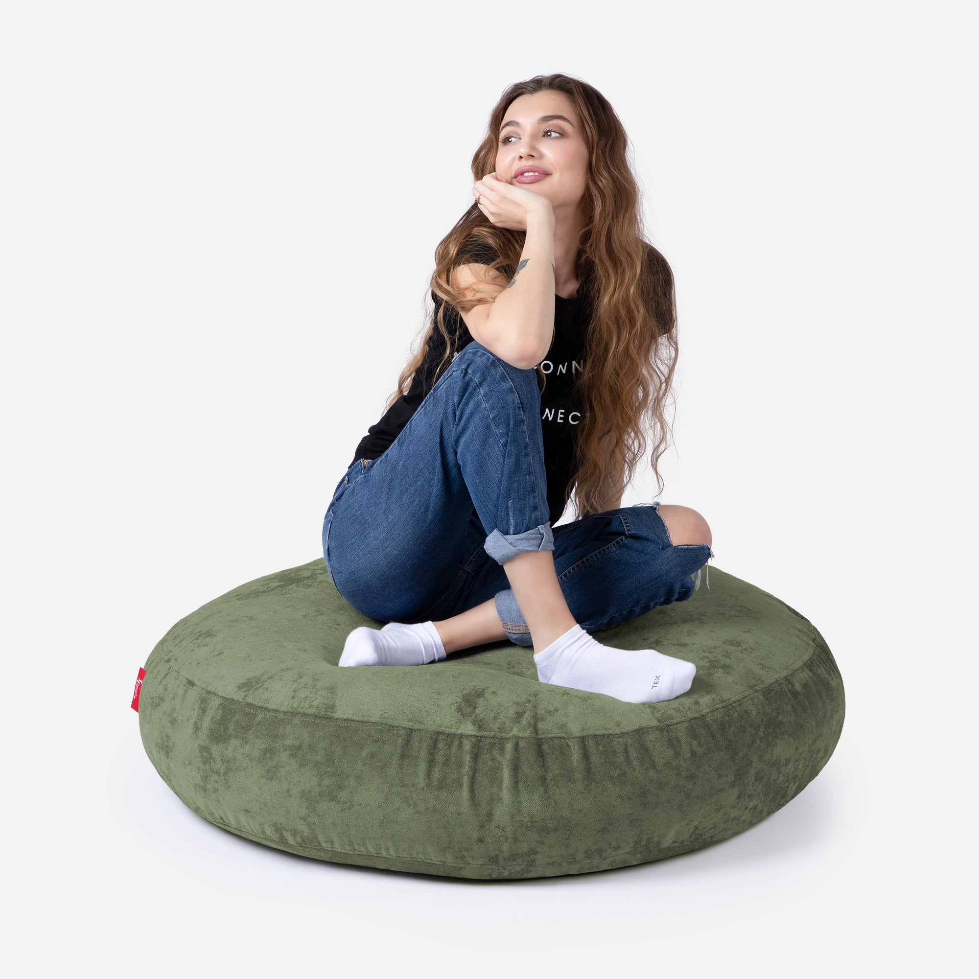 Pouf, Ottoman Khaki color by Lanny with girl seating on it 