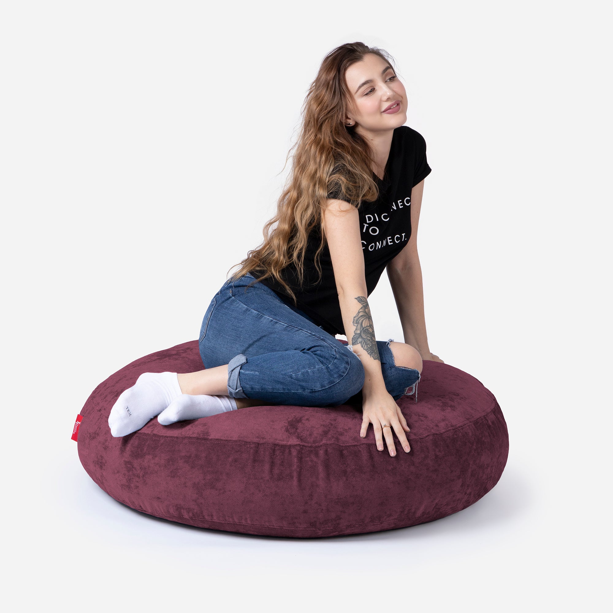 Pouf, Ottoman Purple color by Lanny with girl seating on it 