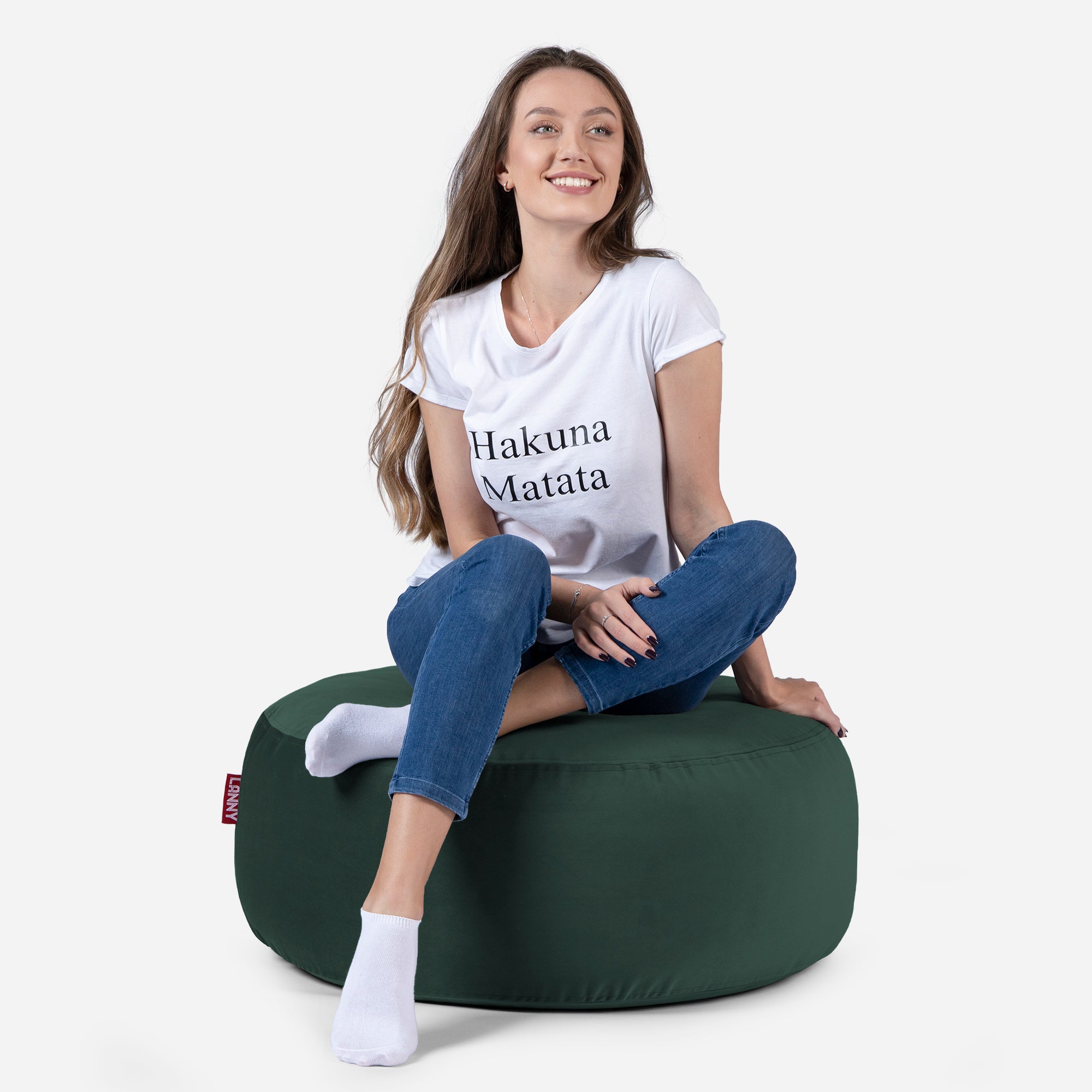 girl siting on Lanny pouf made from velvet fabric in Green color